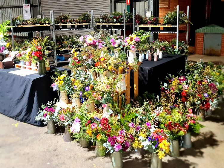 Fiokhea Flowers Market Stall display of colourful flowers in jugs and on stands at Capital Region Farmers market